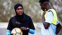 La Soudanaise Salma al-Majidi, première coach d'un club de foot, parle avec un joueur du club régional Al-Ahly, le 17 février 2018 à Al-Gadaref, à l'est de Khartoum [ASHRAF SHAZLY / AFP]