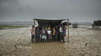 Des réfugiés rohingyas s'abritent de la pluie dans le camp  de Nayapara, au Bangladesh, le 6 octobre 2017 [FRED DUFOUR / AFP]