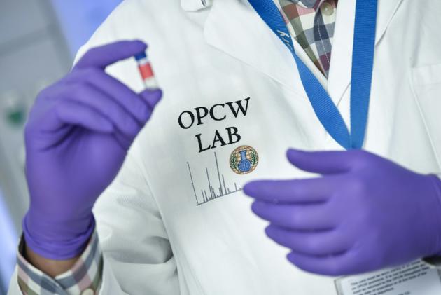 Une analyste teste un échantillon dans les laboratoires de l'Organisation internationale pour l'interdiction des armes chimiques (OIAC) le 20 avril 2018 à La Haye. [JOHN THYS / AFP]
