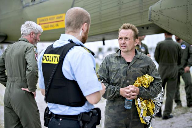 L'inventeur Peter Madsen (d) discute avec un policier le 11 août 2017 dans le port de Dragoer [Bax Lindhardt / Scanpix Denmark/AFP/Archives]