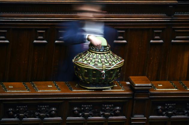 Un député dépose son bulletin dans l'urne lors d'un vote au Sénat à Rome le 24 mars 2018 [Filippo MONTEFORTE / AFP]